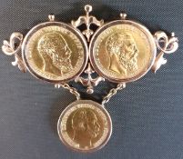 Yellow metal brooch with two mounted 10 Mark 1888 gold coins and one suspended 5 Mark 1877 gold