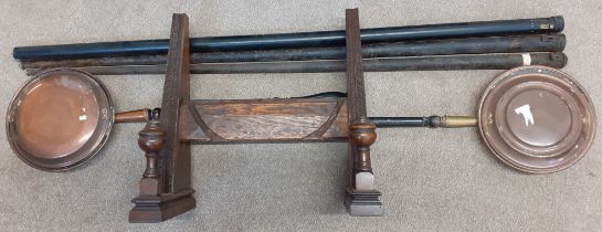 3 snooker cues in metal containers, carved oak display rack & 2 copper warming pans