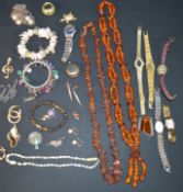 Selection of costume jewellery including amber necklaces