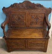 Late 19th/early 20th century heavily carved oak bench with storage compartment L 104cm Ht 120cm D