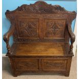 Late 19th/early 20th century heavily carved oak bench with storage compartment L 104cm Ht 120cm D