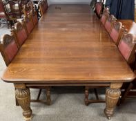 An extremely large late Victorian oak wind out dining table with 5 leaves and cabinet for leaves.