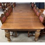 An extremely large late Victorian oak wind out dining table with 5 leaves and cabinet for leaves.