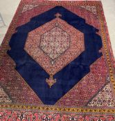 Persian rich blue ground carpet with geometric design 348cm by 252cm