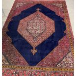 Persian rich blue ground carpet with geometric design 348cm by 252cm