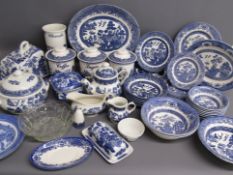 Large collection of Willow pattern dinner and tableware includes cheese plate and cover, tureen,