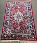 Full pile red ground cashmere rug with traditional medallion design 170cm by 116cm