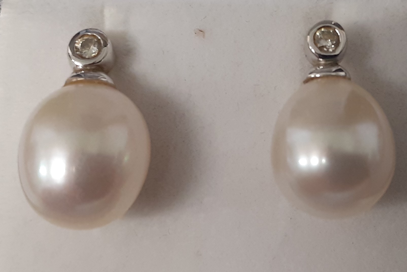 Pair of 18ct white gold, pearl & collet set diamond earrings (marked 750) 3.9g, 10mm pearls