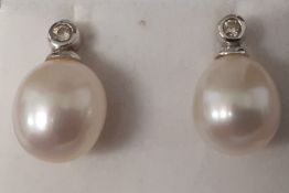 Pair of 18ct white gold, pearl & collet set diamond earrings (marked 750) 3.9g, 10mm pearls