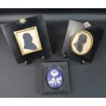 2 nineteenth century framed painted male silhouettes in ebonised frames with acorn hanging