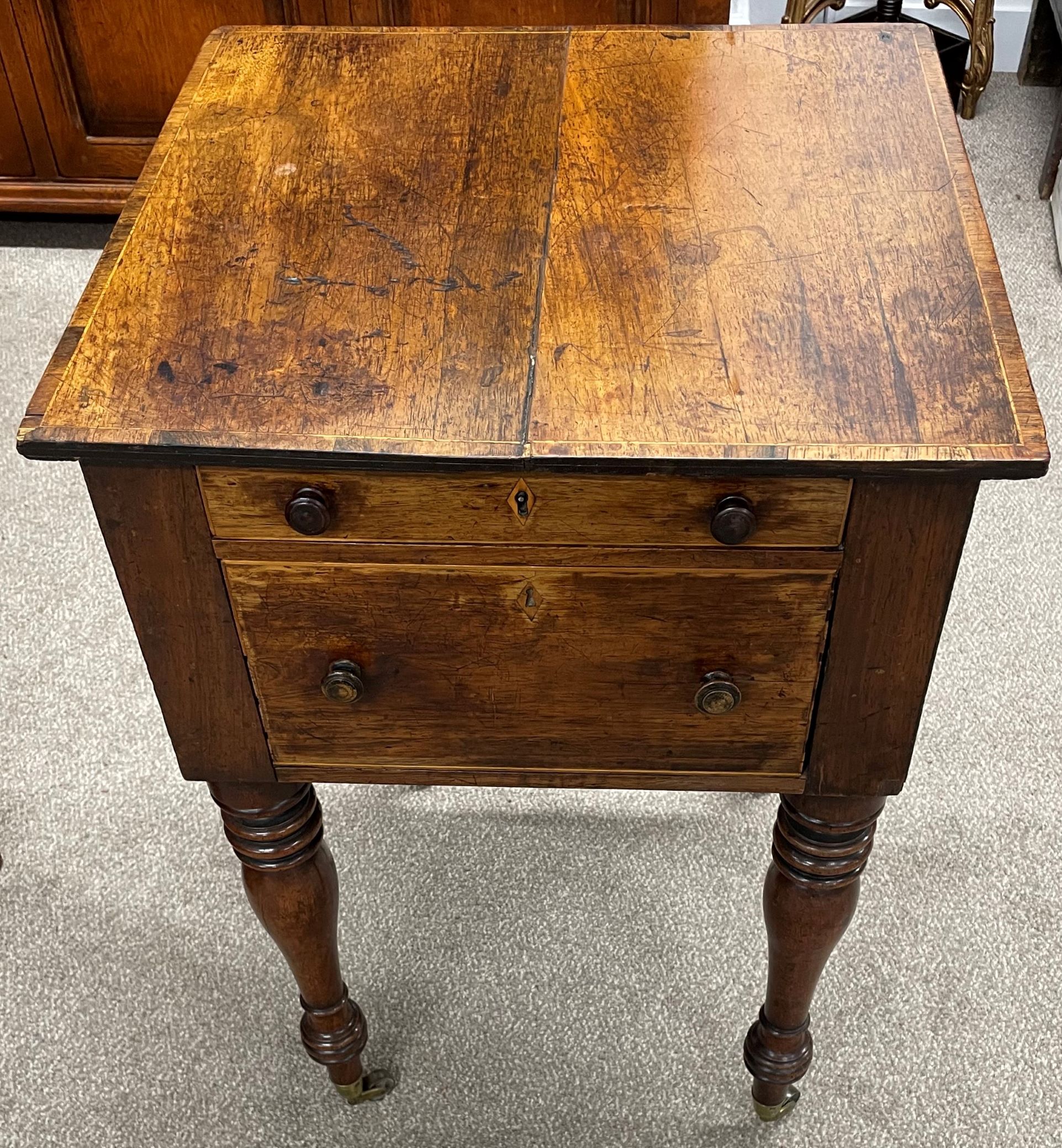 Victorian sewing table on turned legs on castors with two drawers to the front & blind drawers to