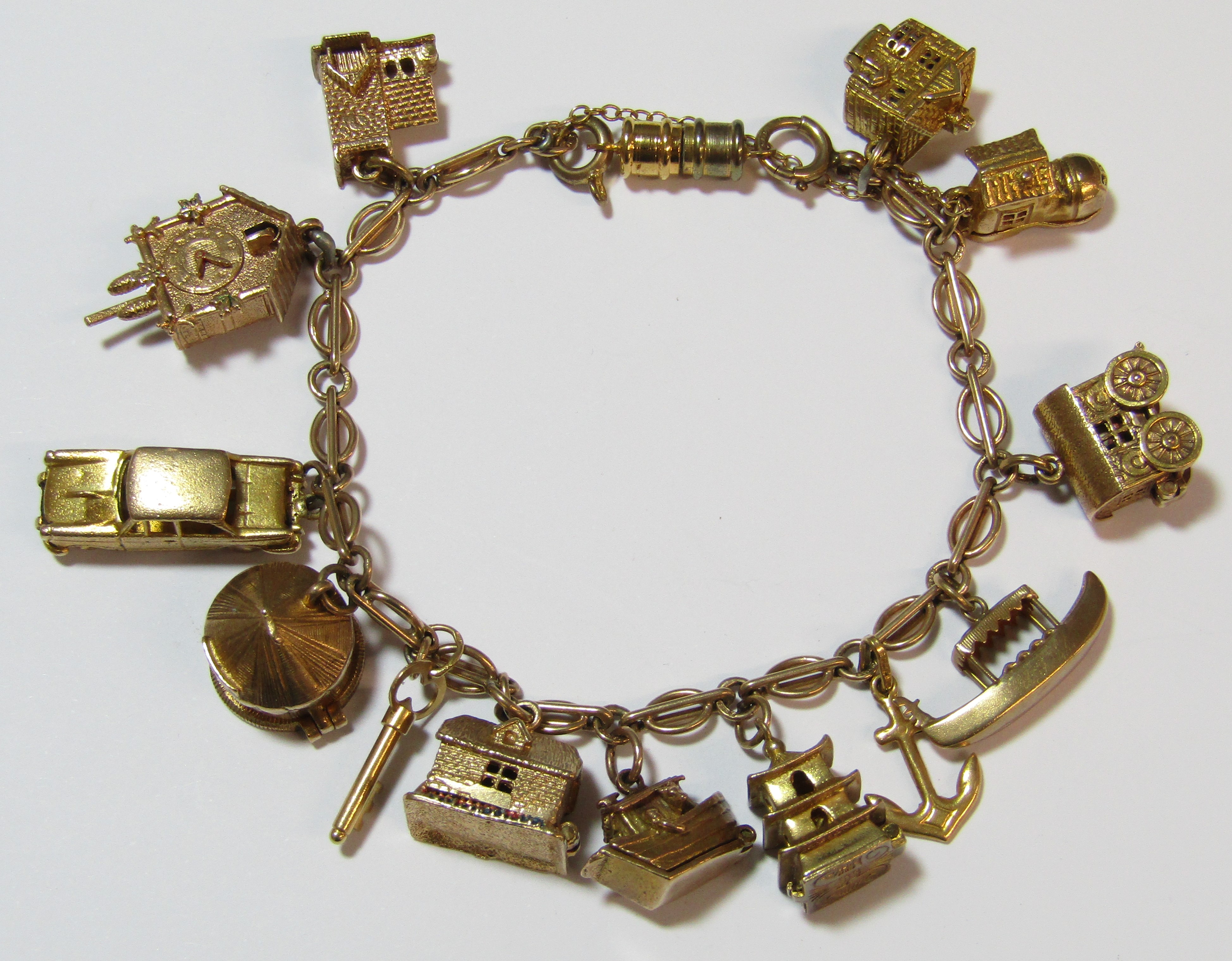 9ct gold charm bracelet - all charms appear hallmarked apart from 'Old Mother Hubbards Boot',