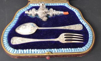 Cased Victorian child's silver rattle, spoon and fork, the cutlery with bright cut engraving and the