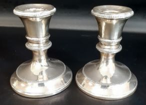 Pair of small silver candlesticks with loaded bases, Mappin & Webb London 1926