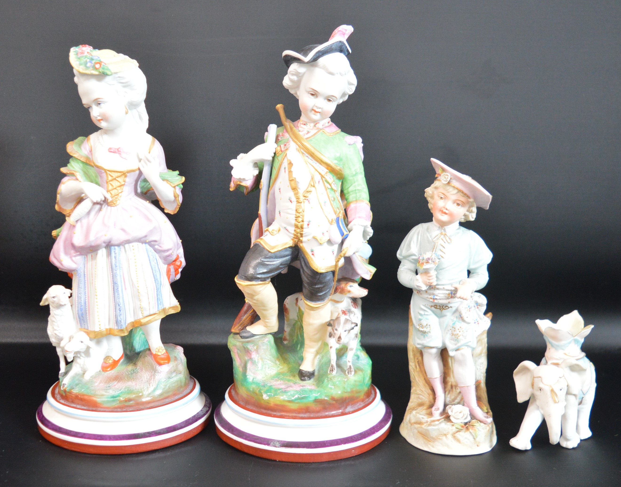 Pair of Continental bisque figurines, boy and girl on naturalistic circular stepped bases, 29cm h,