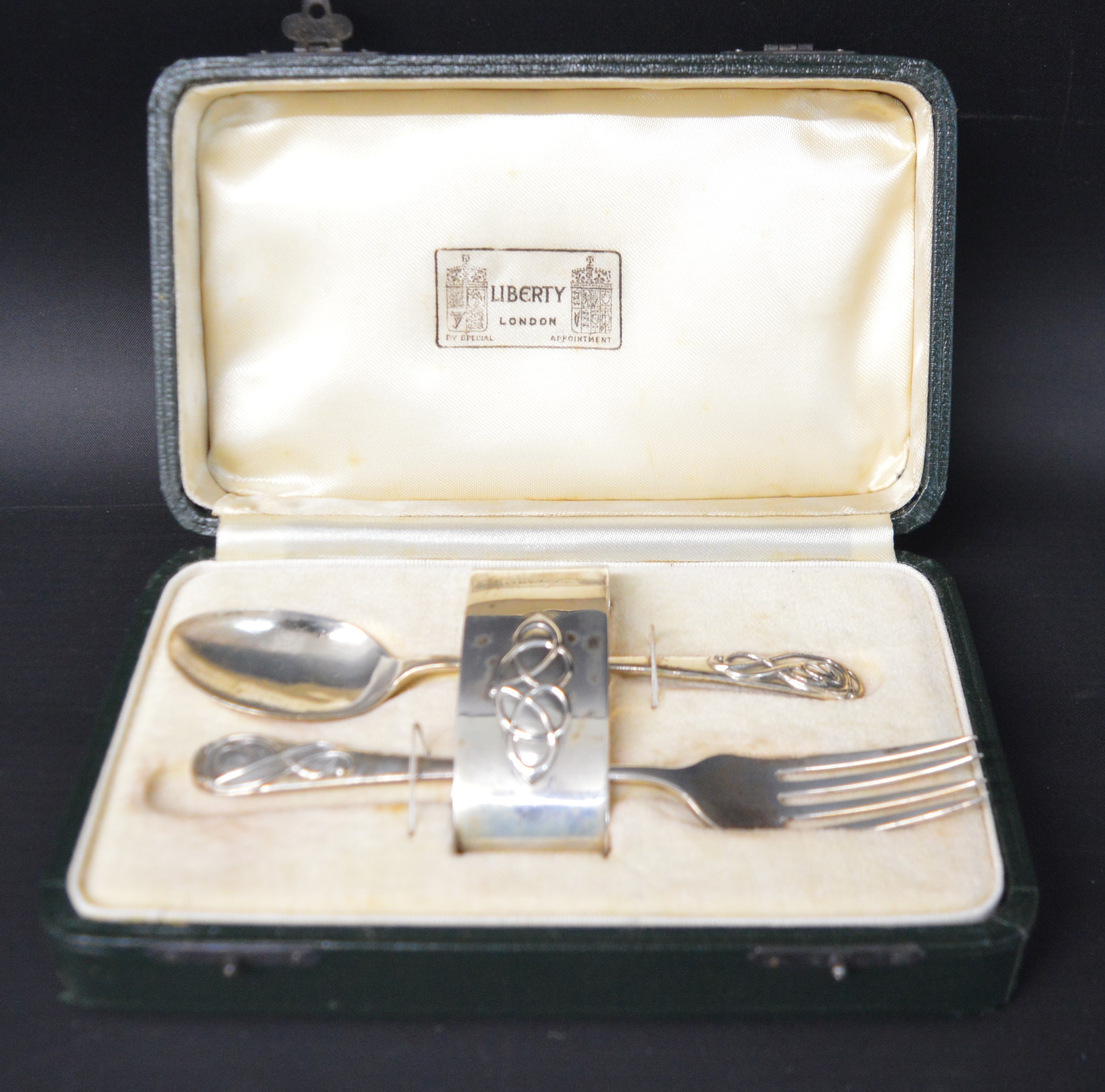 Liberty of London child's cased christening set comprising fork, spoon & napkin ring with Art