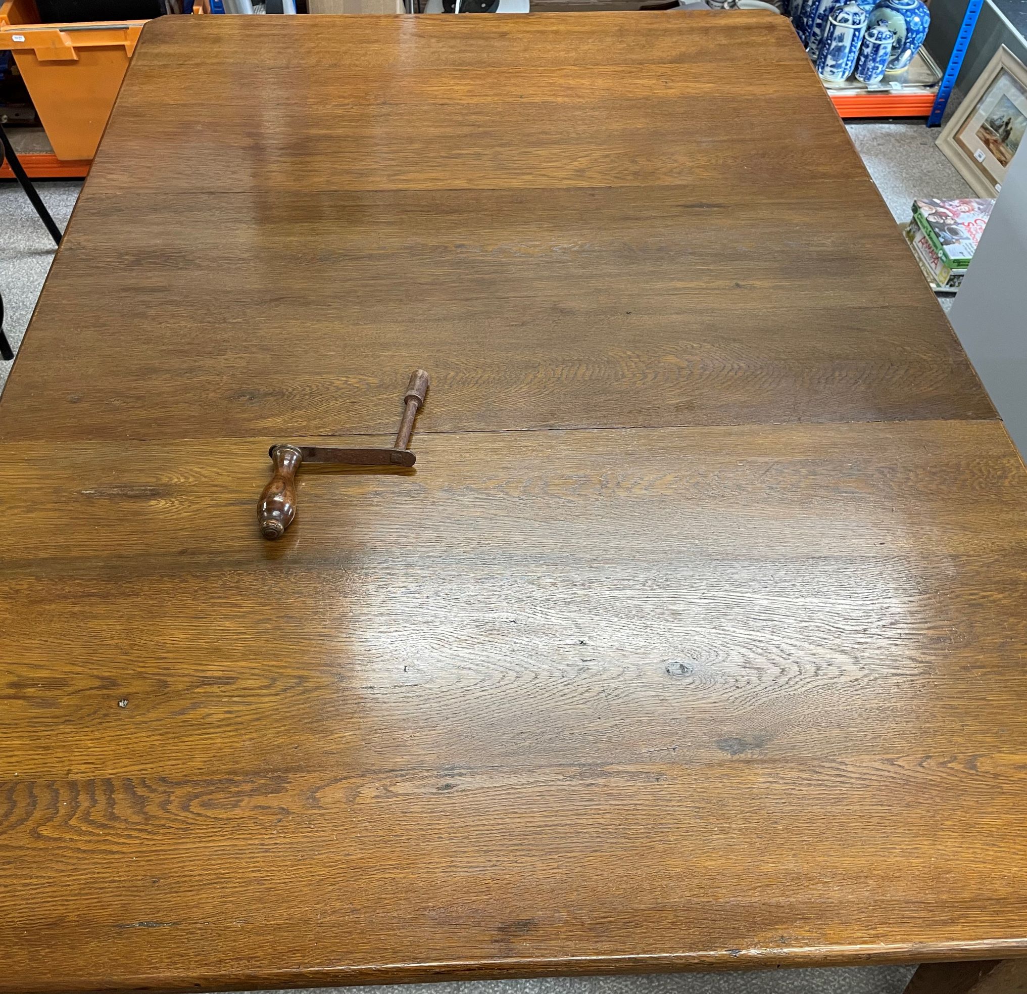 Early 20th century oak wind out dining table with leaf & handle extending to 152cm by 107cm Ht 75cm - Image 2 of 2