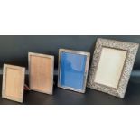 Victorian embossed silver photograph frame 19.5cm x 25.5cm, two smaller silver photograph frames &