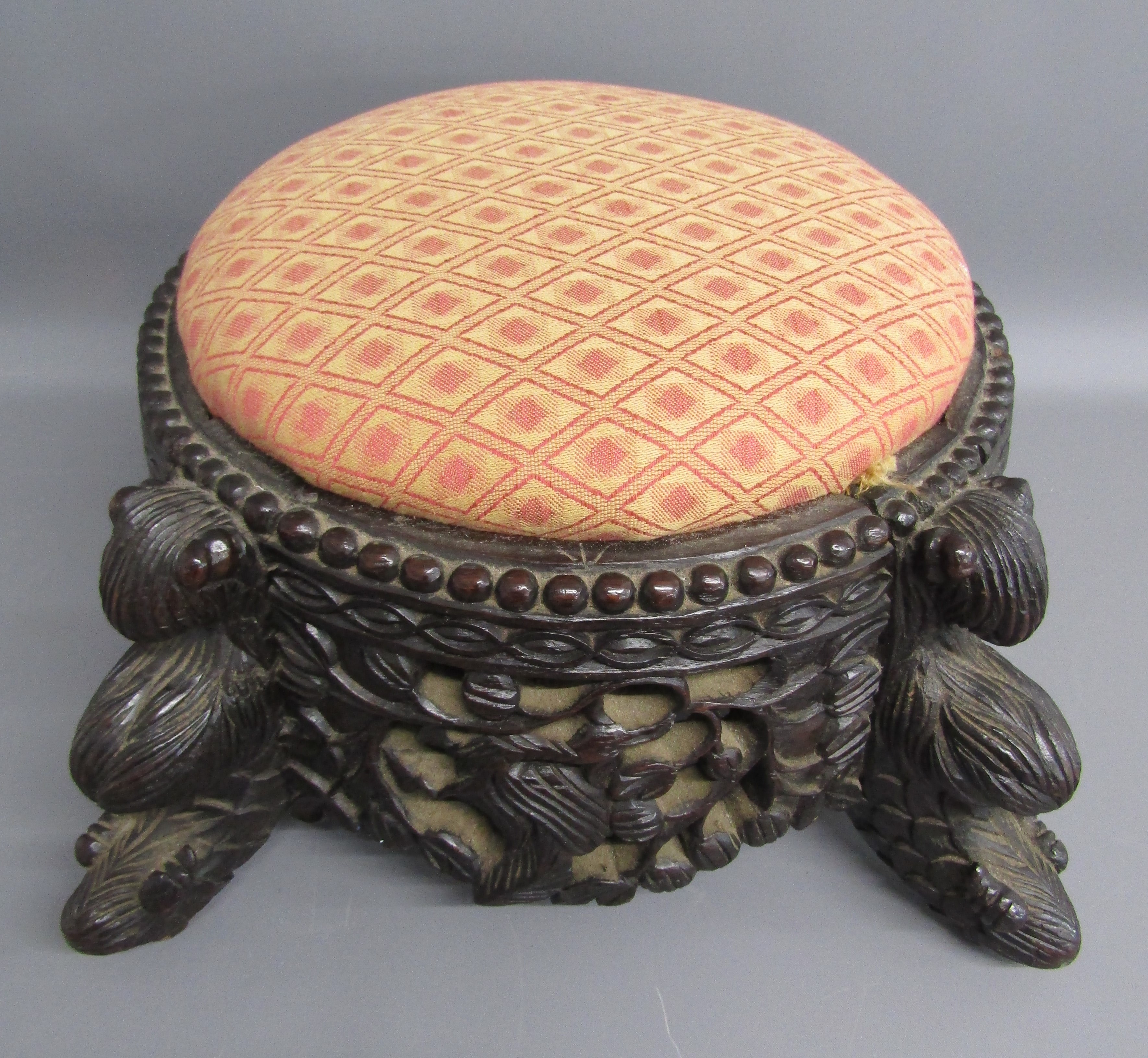 Anglo Indian heavily carved hardwood footstool with fish design legs