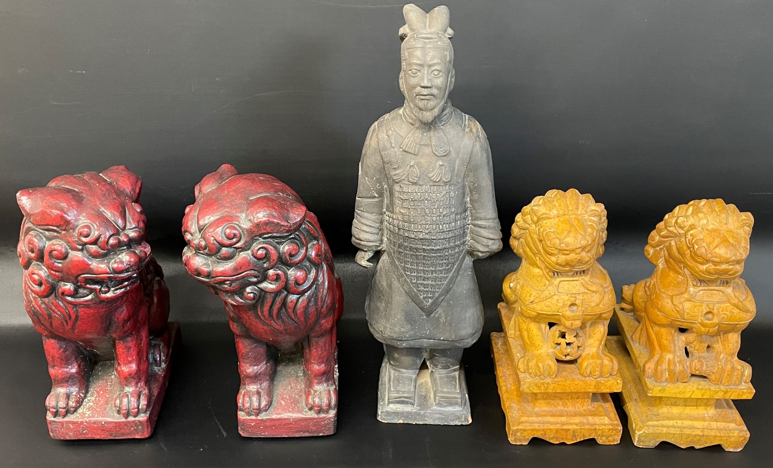 Pair of red cast foo dogs, pair of carved stone foo dogs & a Chinese Terracotta Army figure