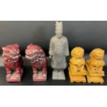 Pair of red cast foo dogs, pair of carved stone foo dogs & a Chinese Terracotta Army figure