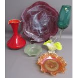 Collection of coloured glass includes over-sized green glass wine glass and purple charger, red jug,