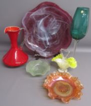 Collection of coloured glass includes over-sized green glass wine glass and purple charger, red jug,