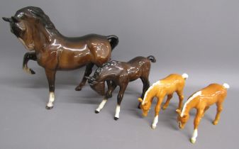 4 Beswick horses - 1549 prancing stallion, 947 foal head down and 2 946 palomino foals with head