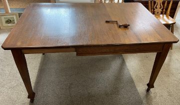 Early 20th century oak wind out dining table with leaf & handle extending to 152cm by 107cm Ht 75cm