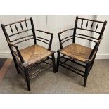 Pair of 19th century William Morris Sussex Carver chairs in ebonised beech & elm with rush seats.