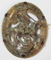 St George and the Dragon oval brooch with intricate detail edging set with glass stones (missing