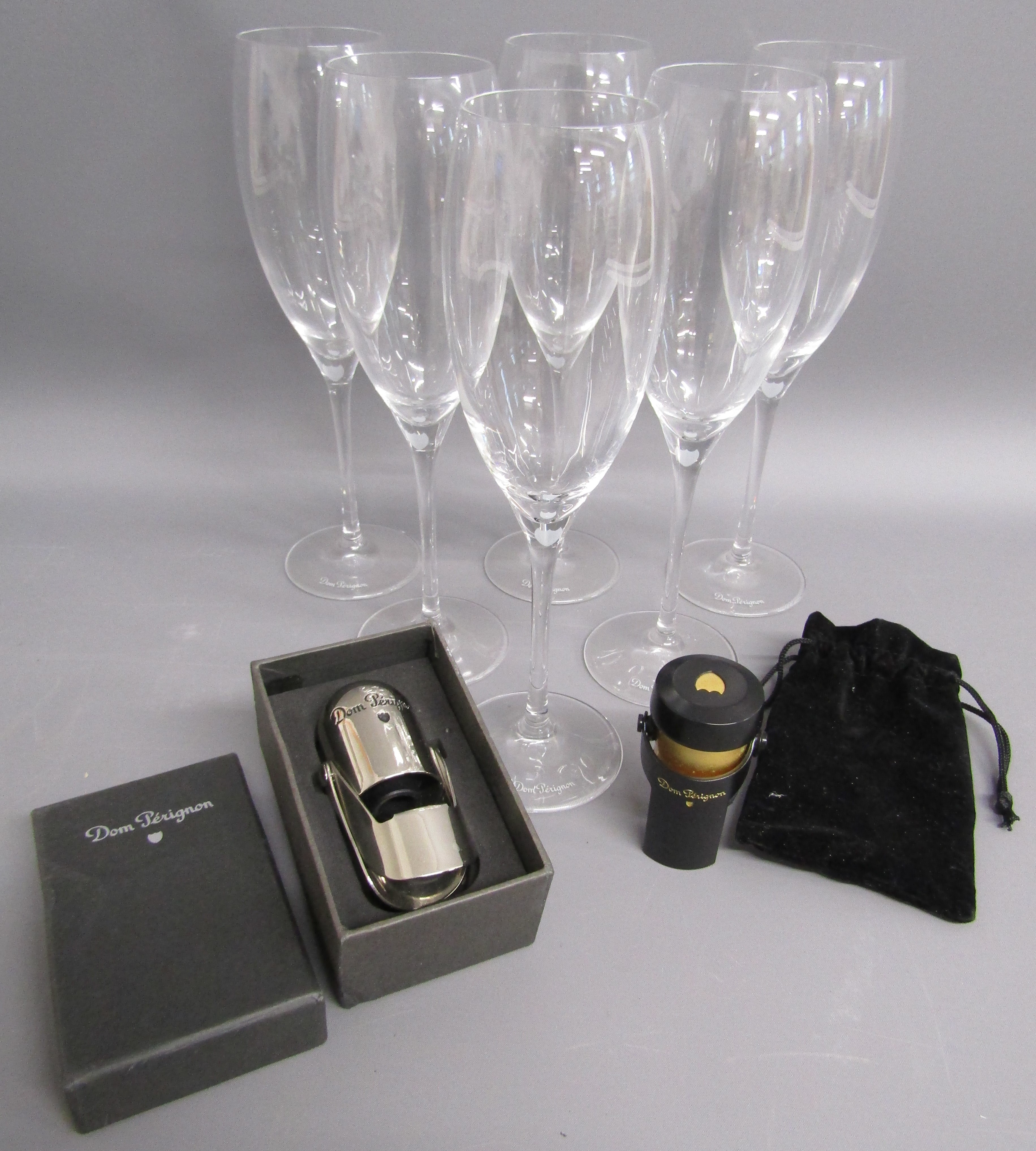 6 Dom Perignon champagne flutes and 2 Dom Perignon bottle stoppers