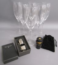 6 Dom Perignon champagne flutes and 2 Dom Perignon bottle stoppers