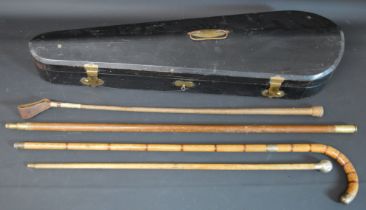 Coffin type violin case, riding crop & three walking sticks