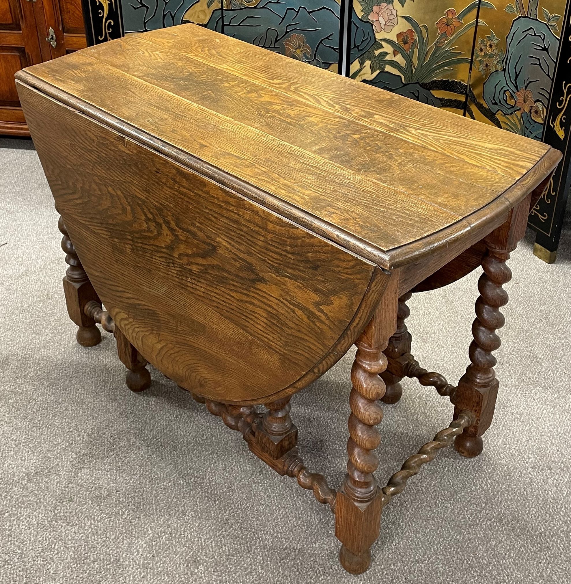 Early 20th century oak gate leg table with barley twist legs 143cm by 106cm Ht 73cm