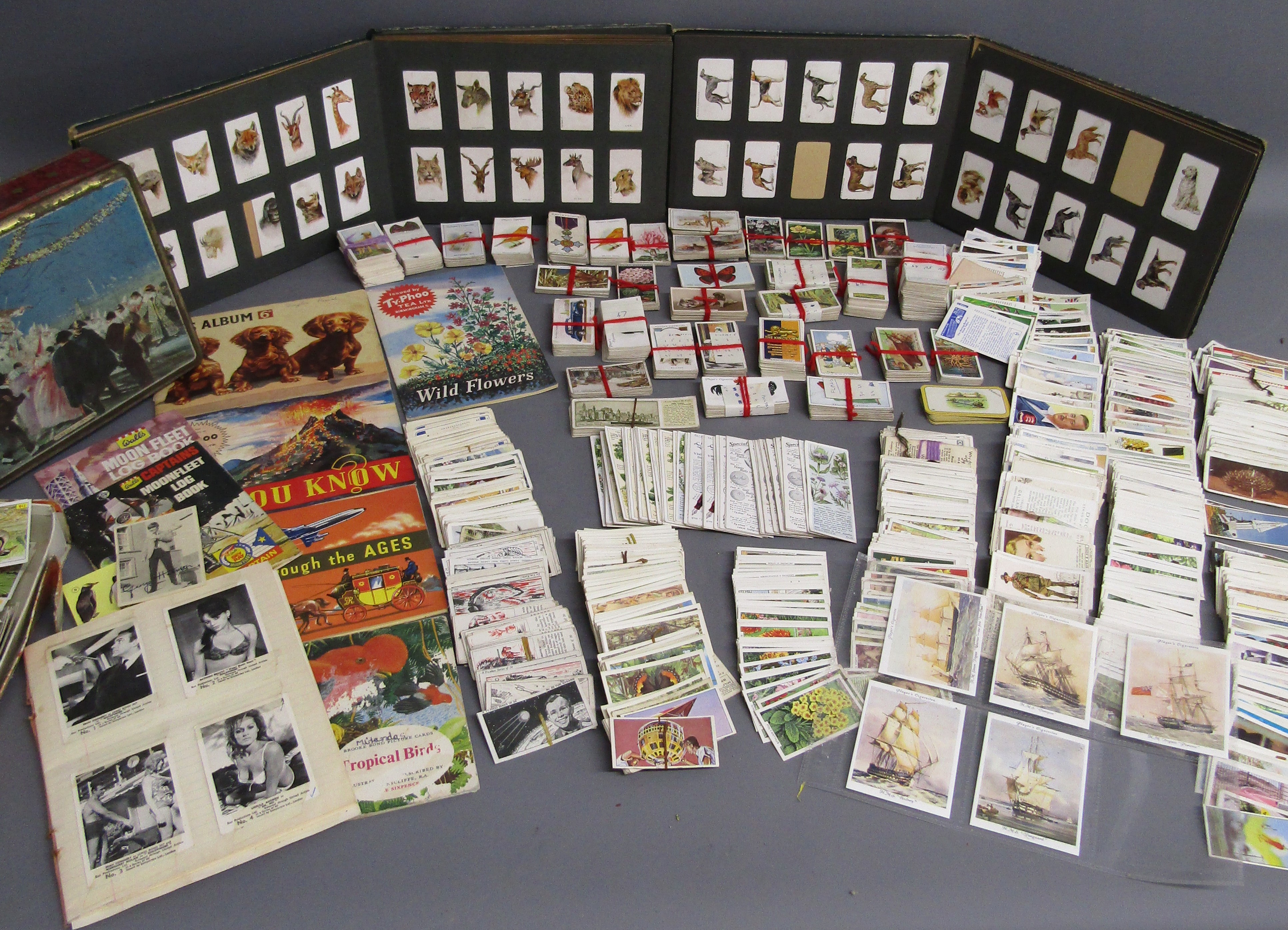 Collection of cigarette cards includes James Bond issued by Somportex Ltd 1-60 taped into book