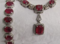 Silver ruby and diamond effect necklace with similar bracelet