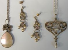 Two silver pendants on chains, one Art Nouveau style and one with mother of pearl drop and a pair of