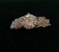 Diamond and platinum ring with diamond set shoulders - centre six claw set with a brilliant cut