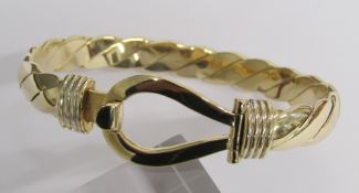 9ct gold bangle with twist design and hook and loop fastening - total weight 61.7g