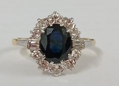 Tested as 18ct gold sapphire & diamond cluster ring, central sapphire approx. 1.30ct surrounded by