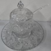 Cut glass punch bowl with ladle and eleven single handled matching glasses on cut glass tray.