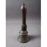 An early 19th century Indian bell metal hand bell with turned hardwood handle, 7 1/2" high