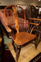 An ash and elm Windsor armchair with panel seat and crinoline stretcher