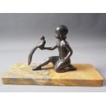 An Art Deco bronzed figure group, girl with bird, on yellow marble base, 11" wide