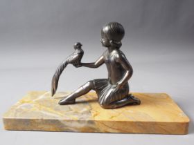 An Art Deco bronzed figure group, girl with bird, on yellow marble base, 11" wide
