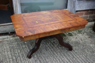 A Sorrento style low octagonal occasional table with central bird decoration, on tripod supports,