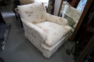 An Edwardian deep seat low armchair with down loose cushions and linen loose covers, on square