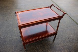 A mahogany and inlaid two-tier tea trolley