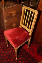 A 19th century carved giltwood occasional chair, upholstered in a red velvet